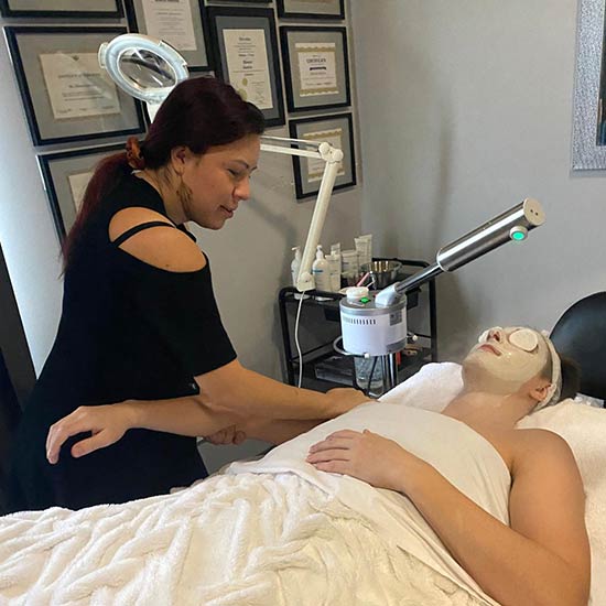 Blanca giving a massage on the arm during a facial